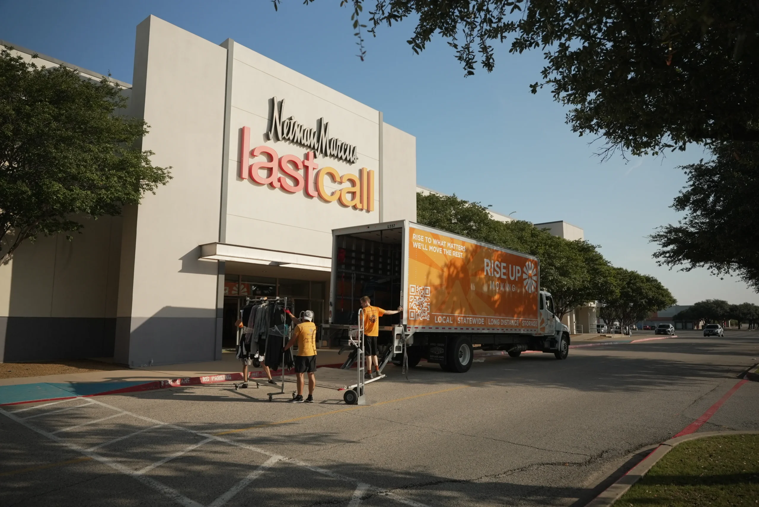 Rise Up Moving crew loading a truck outside a Neiman Marcus Last Call store